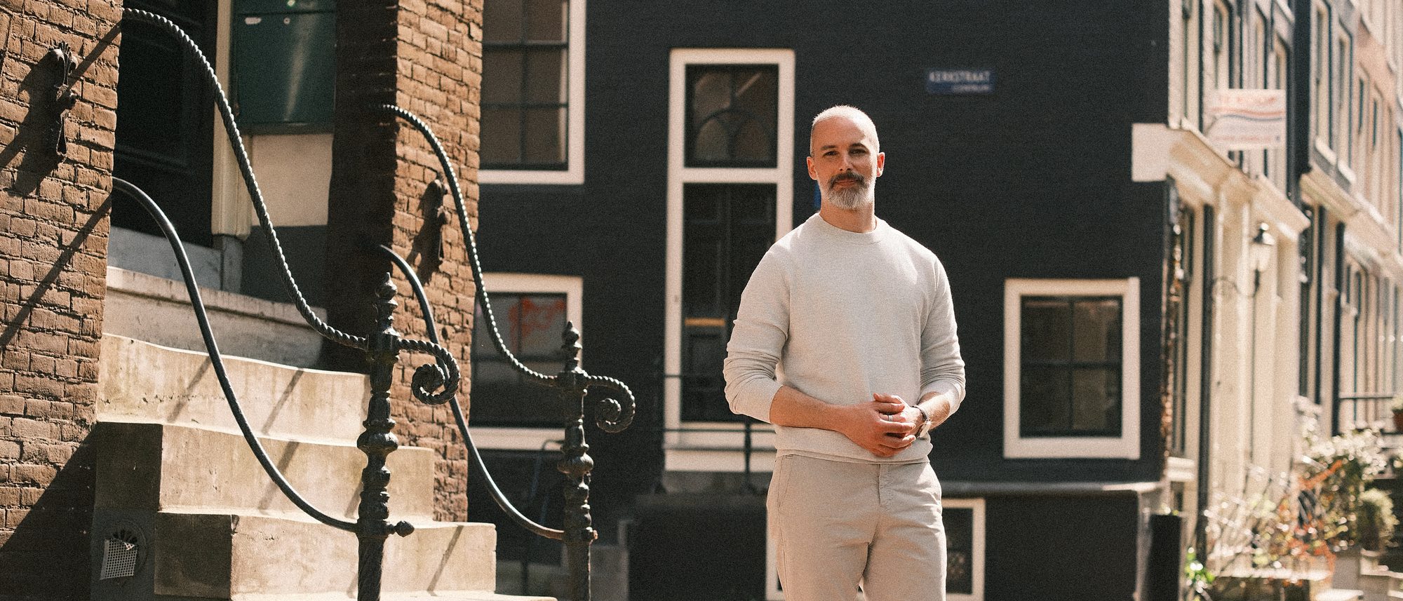Michel Guerreiro standing on a canal-side street in Amsterdam